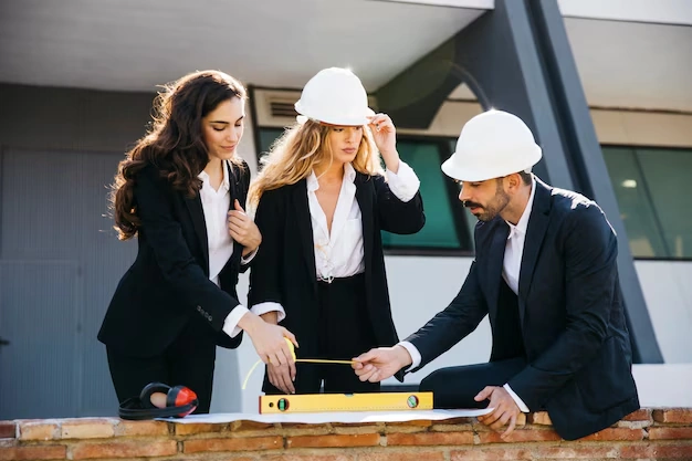 Architects wearing helmets with level 23