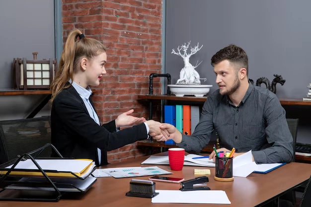 Hardworking confident professional team discussing one issue documents office