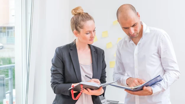 Male female businesspeople looking schedule diary 23