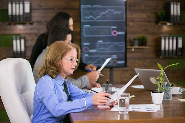 Middle age executive female reading charst conference room young businesswoman background 31194