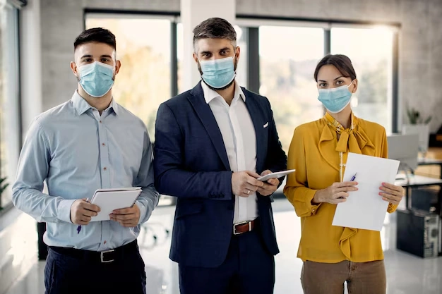 Portrait business team with protective face masks office 10573