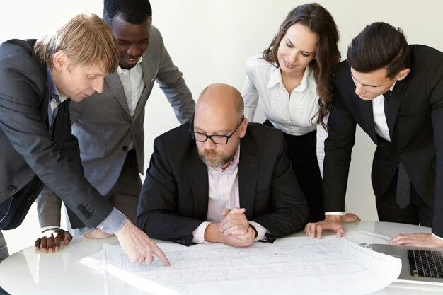 Team architects studying blueprints meeting while working new engineering project 6001